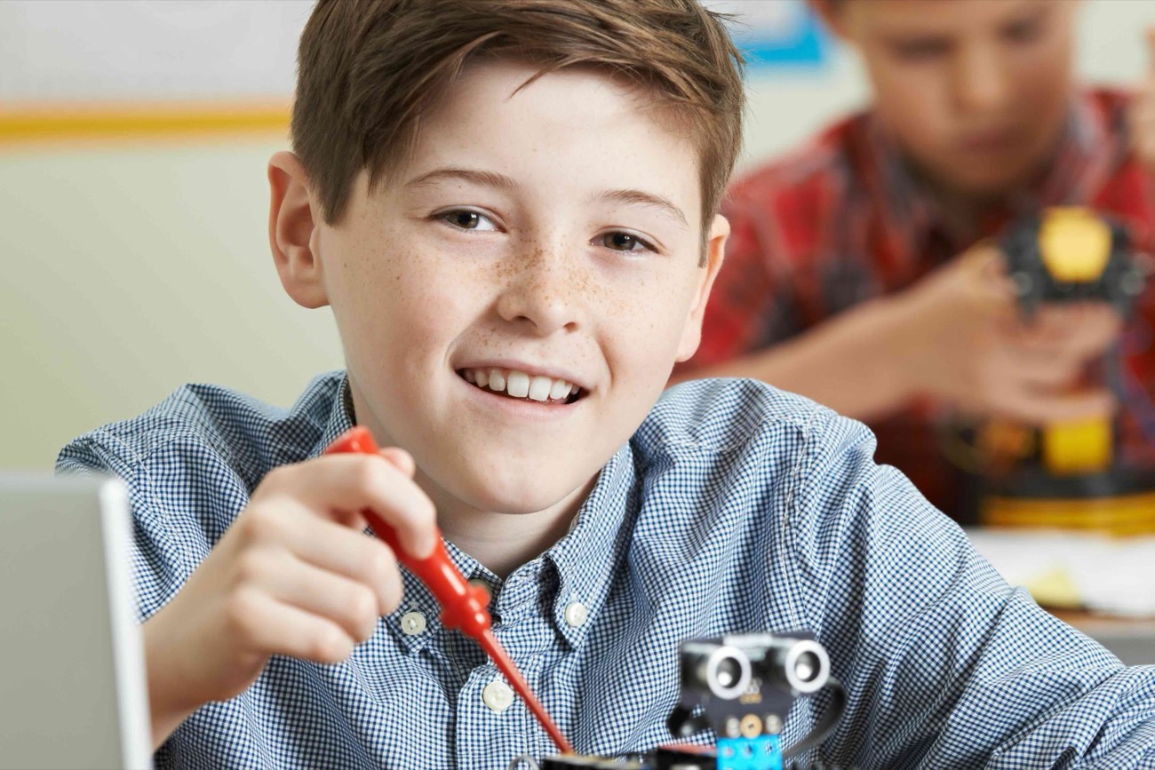 A student building and programming a robot at BCE Coding